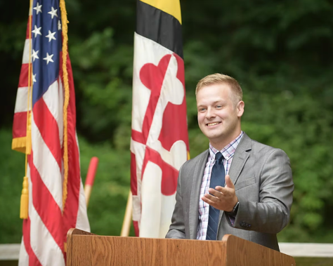 Brandon Paulin speaking at an outdoor podium